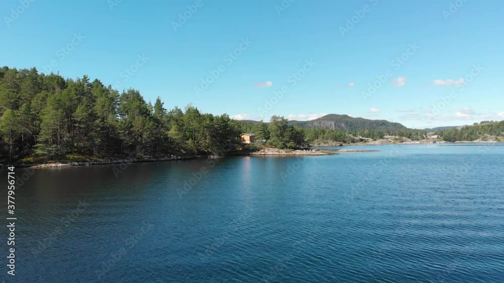 Picturesque Norwegian fishing cabin on beautiful fjord islet, aerial view Picturesque Norwegian fishing cabin on beautiful fjord islet, aerial view