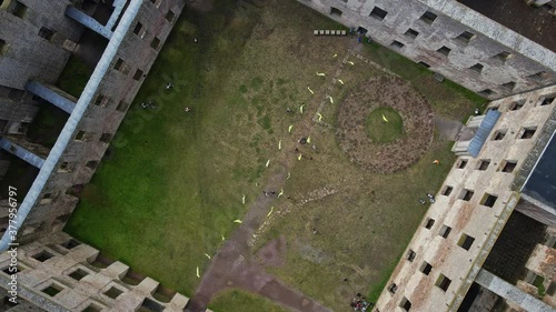 People In The Old Ruin Of Borgholm Castle In Oland, Sweden - top-down shot, aerial drone ascend photo