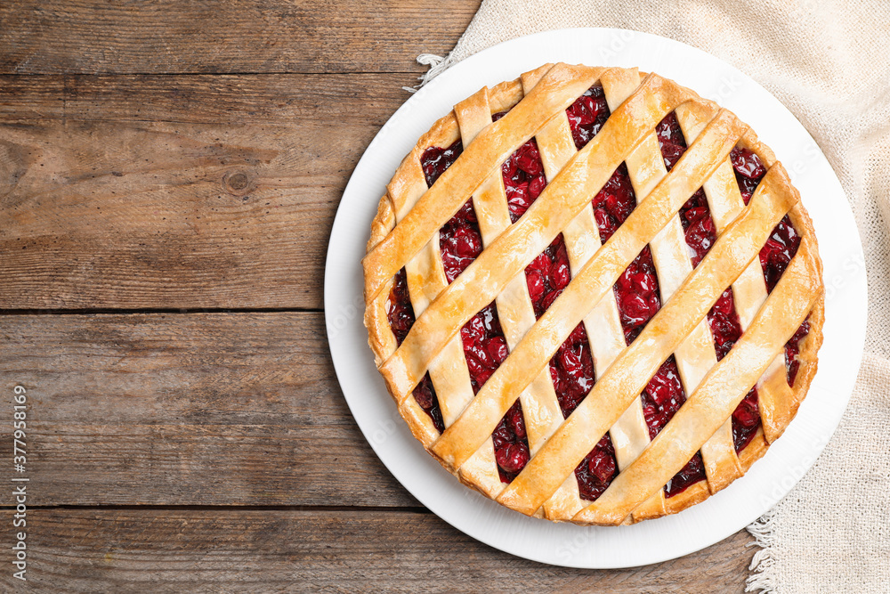 Delicious fresh cherry pie on wooden table, top view. Space for text Delicious fresh cherry pie on wooden table, top view. Space for text