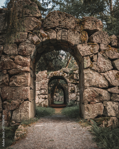 Old stone ruins with archway paths in a Finnish park