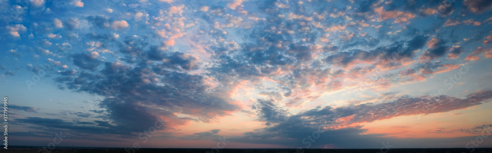 Panorama, cloudy sky at sunset. Pink clouds.