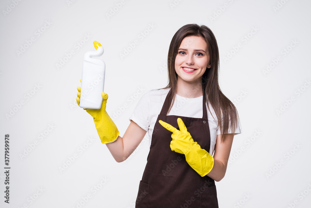 Smiling woman pointing to bottle with kitchen cleaner isolated on white background Smiling woman pointing to bottle with kitchen cleaner isolated on white background