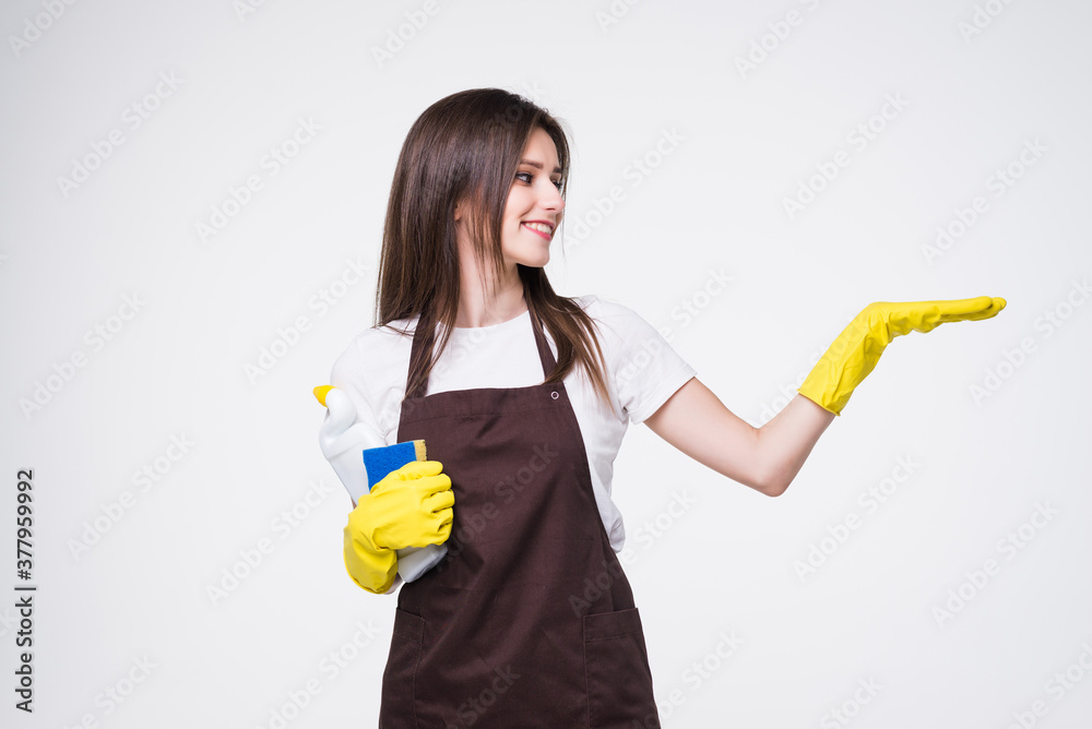 Young woman cleaner with hand show with blank sign isolated on white background Young woman cleaner with hand show with blank sign isolated on white background