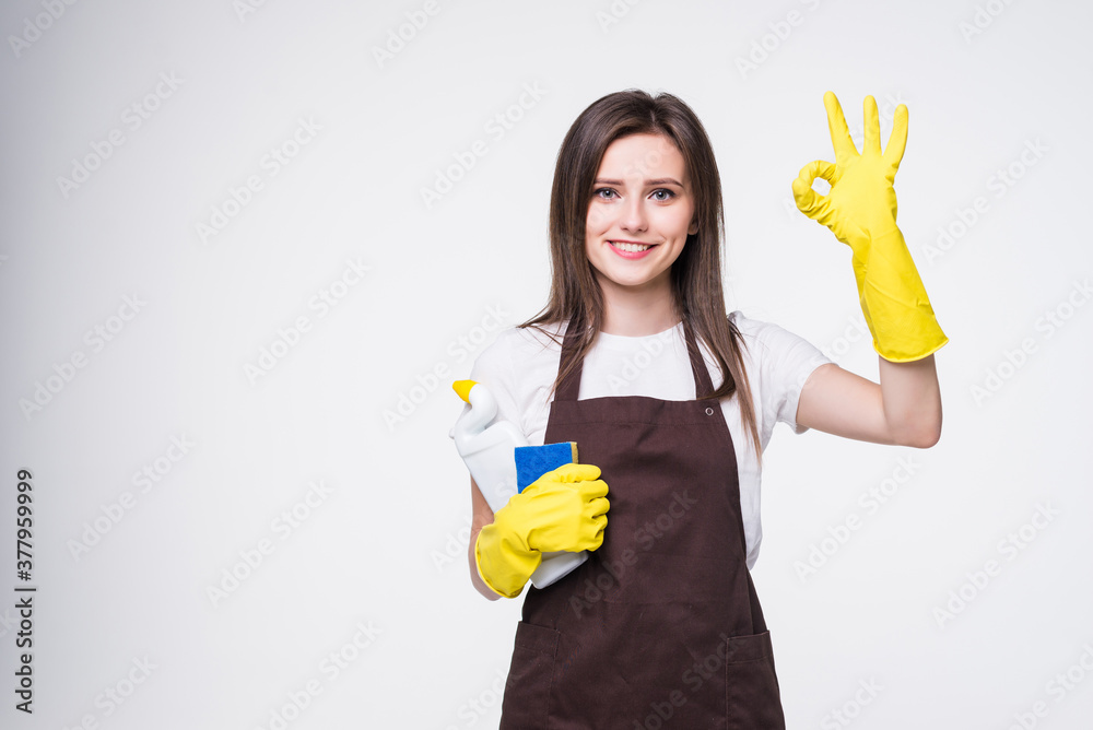 Cheerful housekeeper female showing ok sign as great cleaning services concept isolated on white background Cheerful housekeeper female showing ok sign as great cleaning services concept isolated on white background