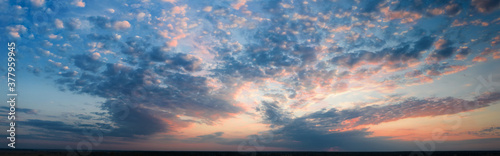 Panorama, cloudy sky at sunset. Pink clouds.