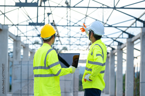 Engineer using laptop working on building site,Construction concept.