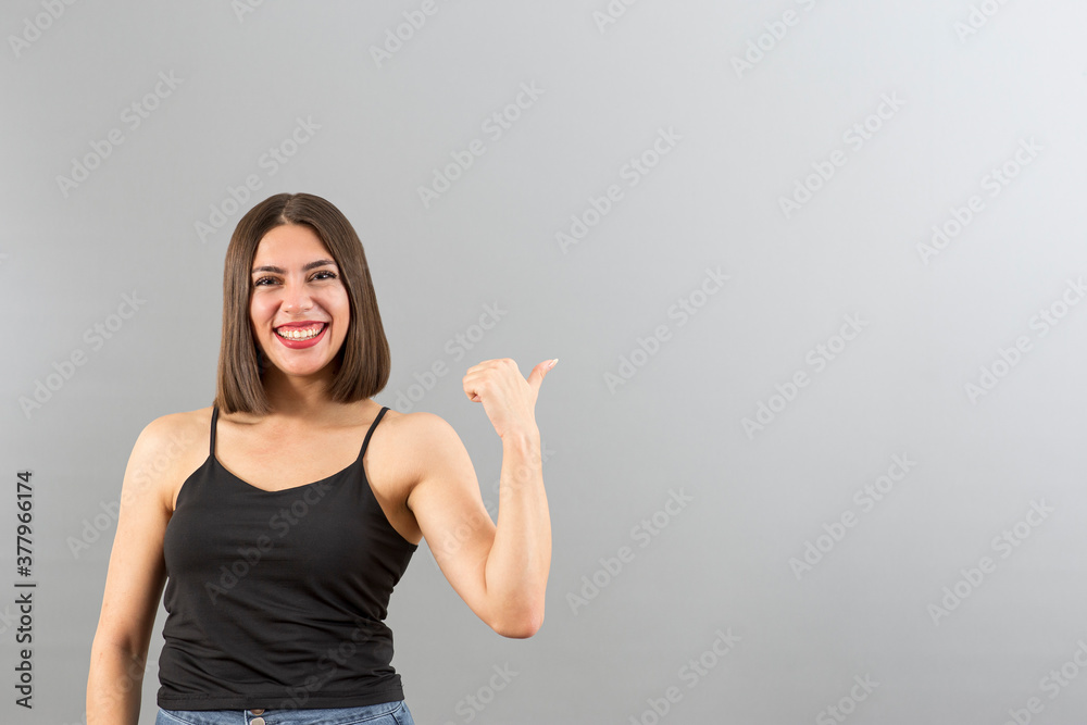 Attractive Turkish woman portrait in positive mood. She is gesturing thumbs up. Attractive Turkish woman portrait in positive mood. She is gesturing thumbs up.
