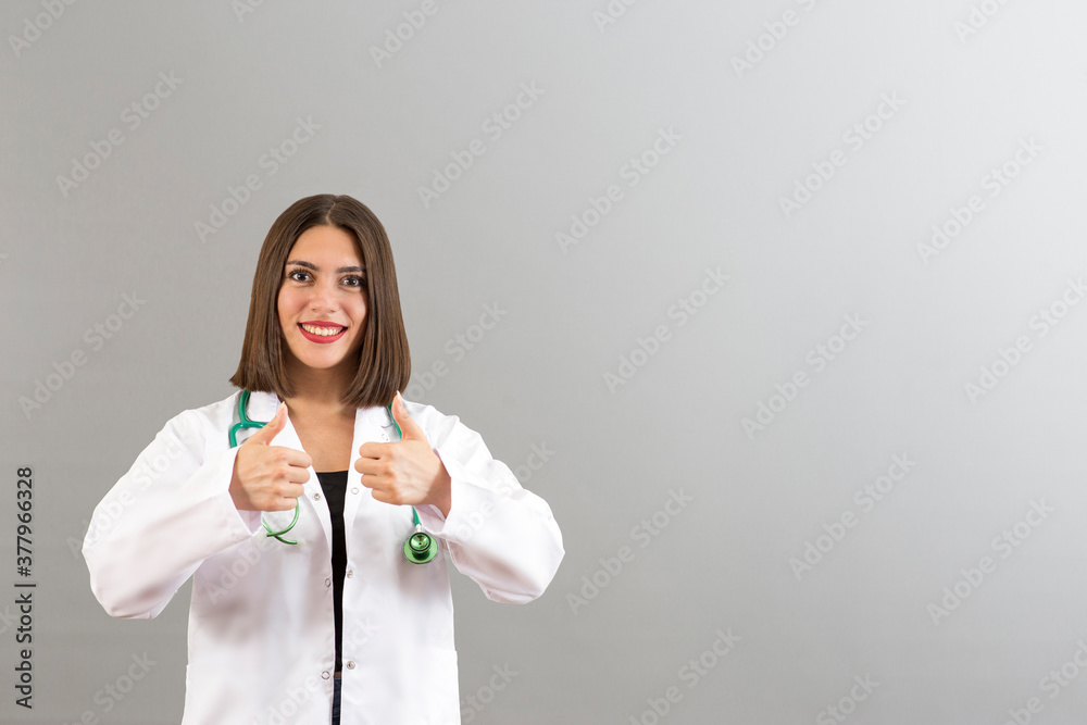 Beautiful smiling Turkish woman doctor portrait in studio she is confident mood, she is gesturing thumbs up Beautiful smiling Turkish woman doctor portrait in studio she is confident mood, she is gesturing thumbs up