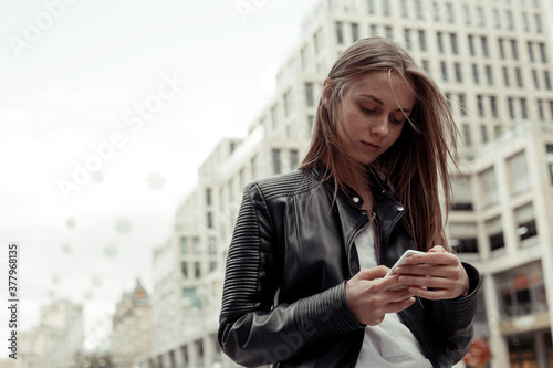 Free Download Woman wearing black leather jacket and white shirt write a phone message - GFXLoad