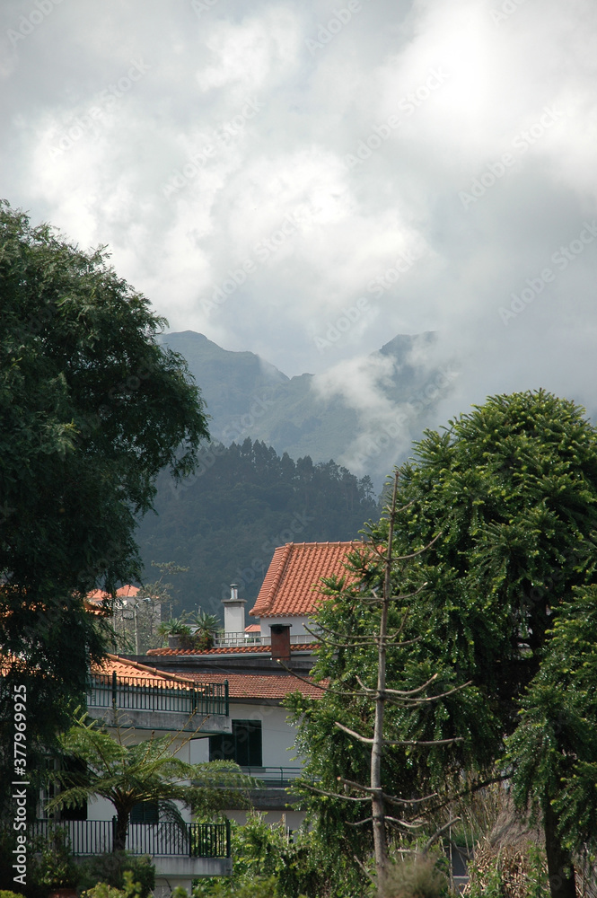 Sunshine on clouds and houses at Madeira Island Sunshine on clouds and houses at Madeira Island