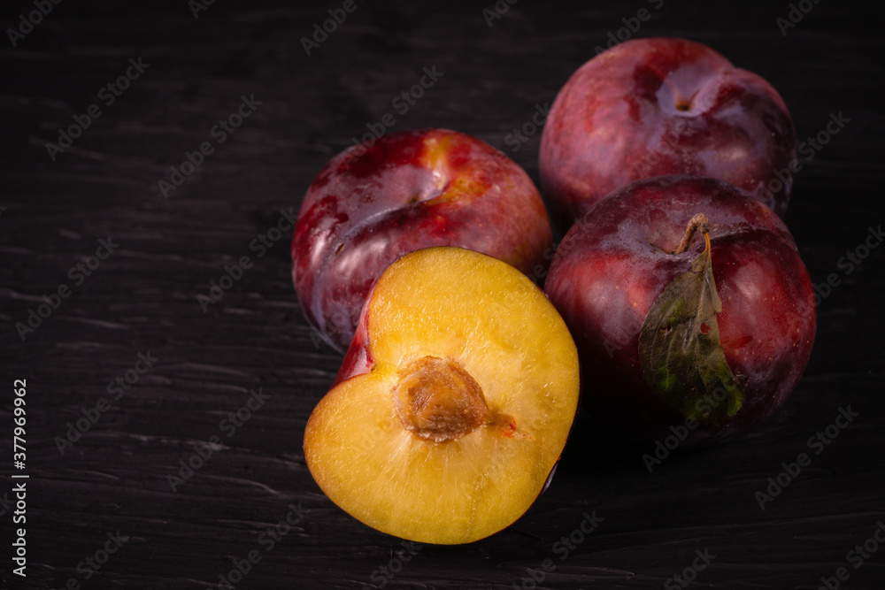 Purple plum on black background Purple plum on black background