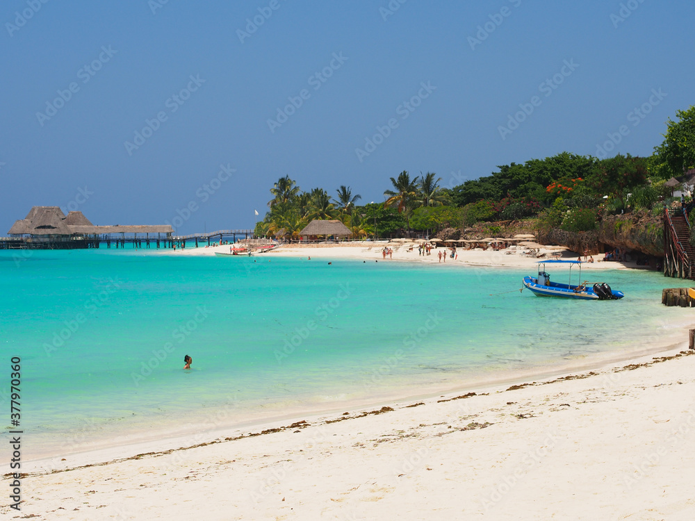 Sunny beach day, white sand, blue Indian ocean in Zanzibar island, Tanzania. Copy space for text.