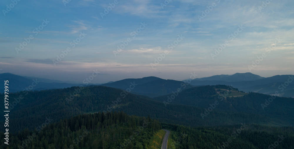 Mountain road. Landscape with rocks, sunny sky with clouds and beautiful asphalt road. Travel background. Highway in mountains. Sunrise mountain beautiful view. fog in the mountains. Aerial view.