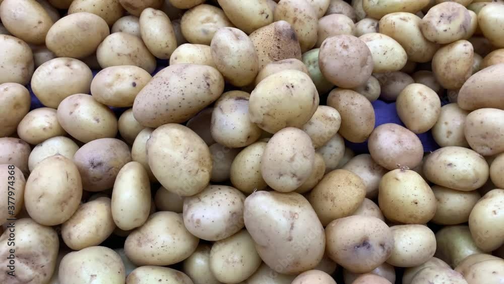 Fresh Organic Potato on Tray at the Farmer Market. A pile of organic potatoes lying in a tray Fresh Organic Potato on Tray at the Farmer Market. A pile of organic potatoes lying in a tray