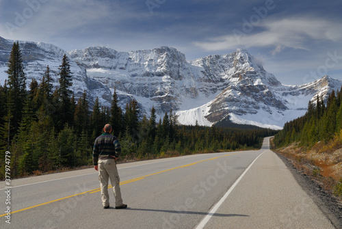 Traveler on Icefields Parkway looking at snow covered Waputik Range Mountains