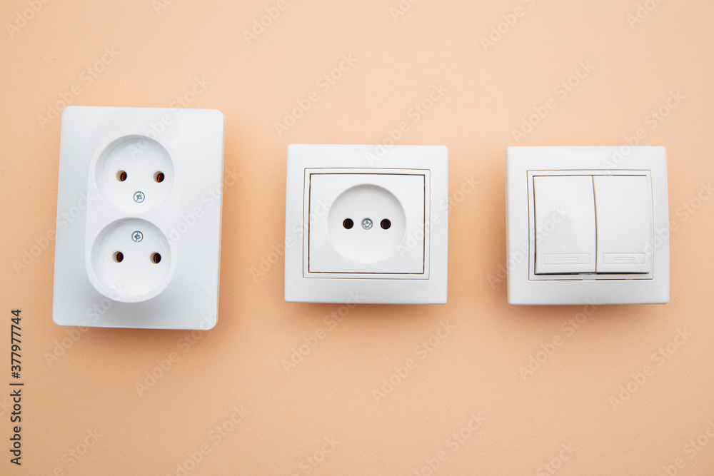 Power sockets and switch on pink table, minimalism concept. Power sockets and switch on pink table, minimalism concept.