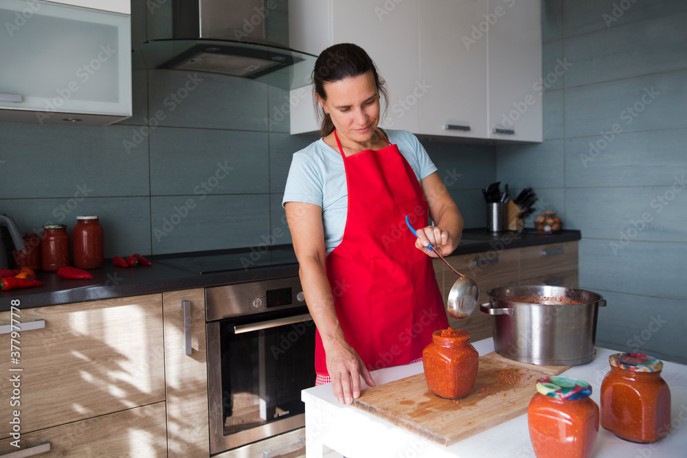 woman process Fermented preserved vegetables in your kitchen. Canned food. healthy diet. homemade vegetable marinade woman process Fermented preserved vegetables in your kitchen. Canned food. healthy diet. homemade vegetable marinade
