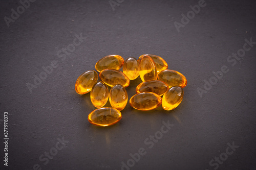 Omega 3 capsules on black background photo