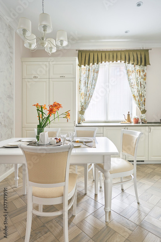 Classic white kitchen with served dining area