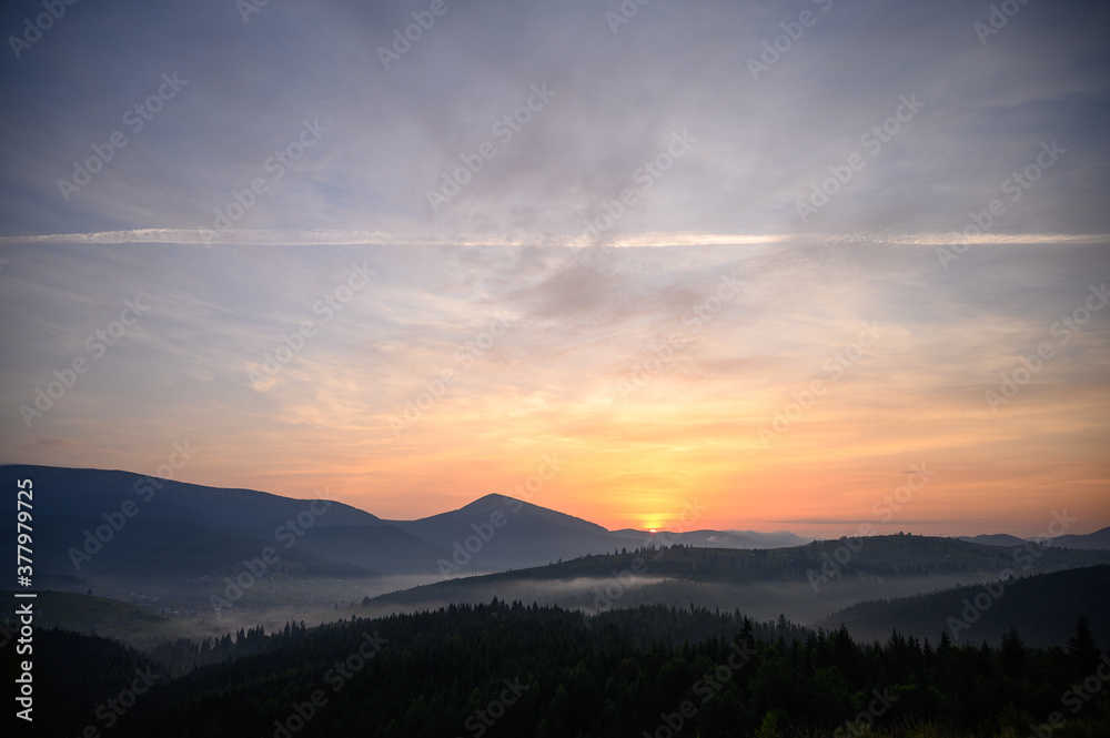 mountains landscape with sun and alpine pines. Sunrise mountains landscape with sun and alpine pines. Sunrise
