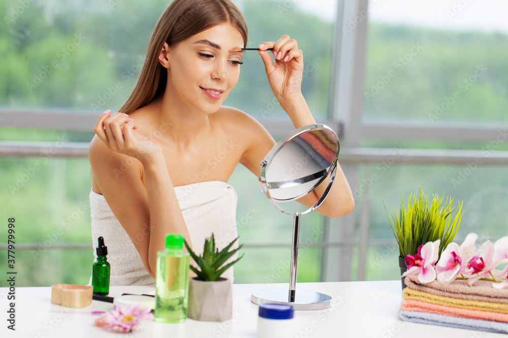Pretty woman applies makeup in the bathroom of elite apartment Pretty woman applies makeup in the bathroom of elite apartment