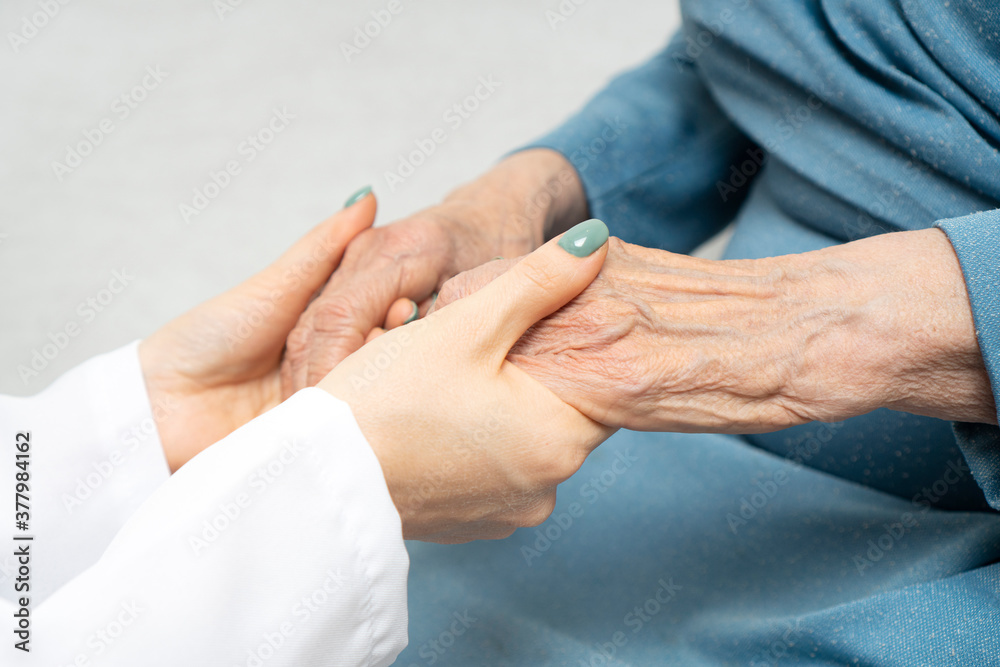 Young nurse hands holding an old hands of senior woman. Support for the elderly concept. Young nurse hands holding an old hands of senior woman. Support for the elderly concept.