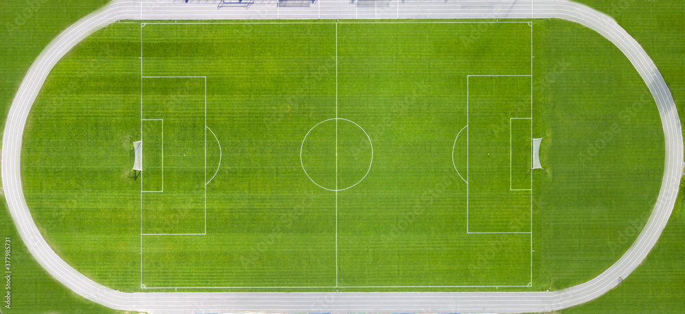 Fototapeta premium Soccer field with white markings. Top view.