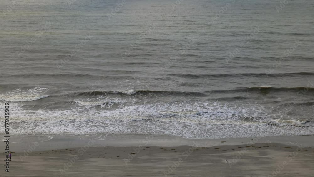 People strolling on the beach just before the hurricane hits People strolling on the beach just before the hurricane hits
