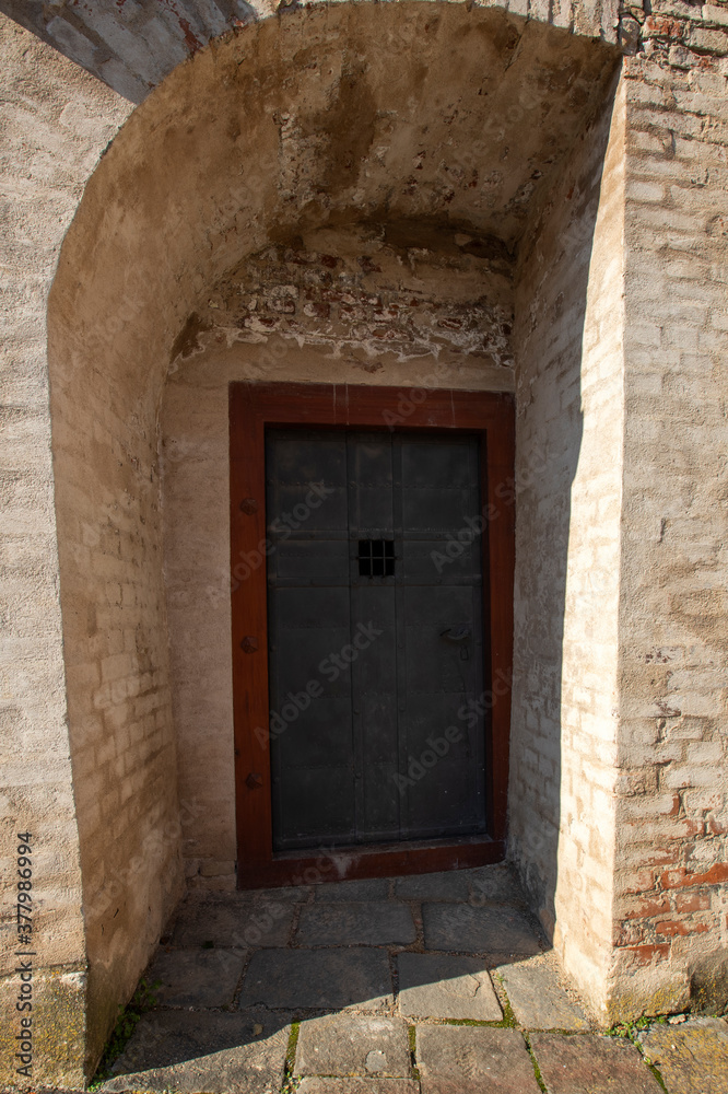 Entrance metal door to the basement. There is a wall around.