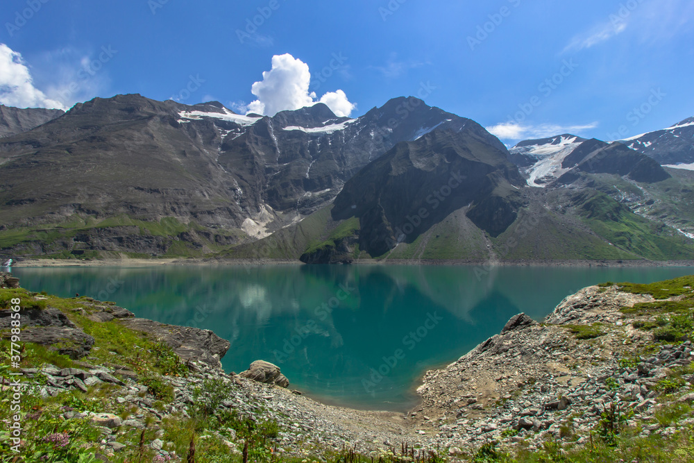 Beautiful view of high mountain lake near Kaprun.Hike to the Mooserboden dam in Austrian Alps.Quiet relaxation in nature.Wonderful nature landscape,turquoise tranquil lake,summer holiday travel scene Beautiful view of high mountain lake near Kaprun.Hike to the Mooserboden dam in Austrian Alps.Quiet relaxation in nature.Wonderful nature landscape,turquoise tranquil lake,summer holiday travel scene