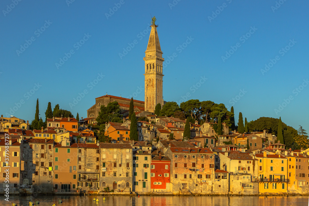 Rovinj,Istria,Croatia.View of the town situated on the coast of Adriatic Sea.Popular tourist resort and fishing port.Old town at sunrise with cobblestone streets, colorful houses and the church tower.