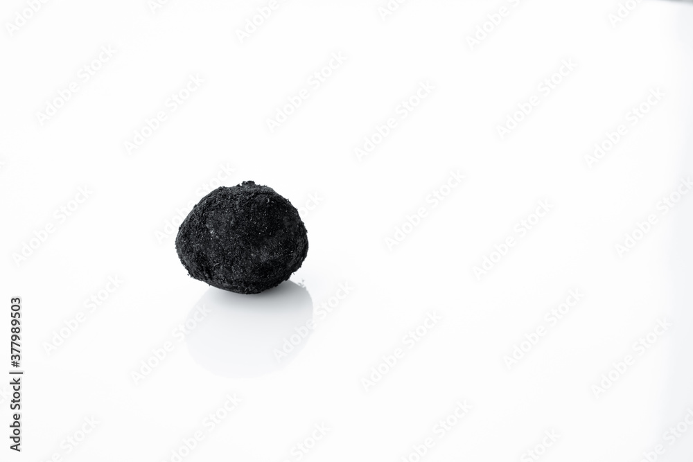 Fototapeta premium An old duck egg recipe in ash. Salty pickled duck egg in ash on a white background