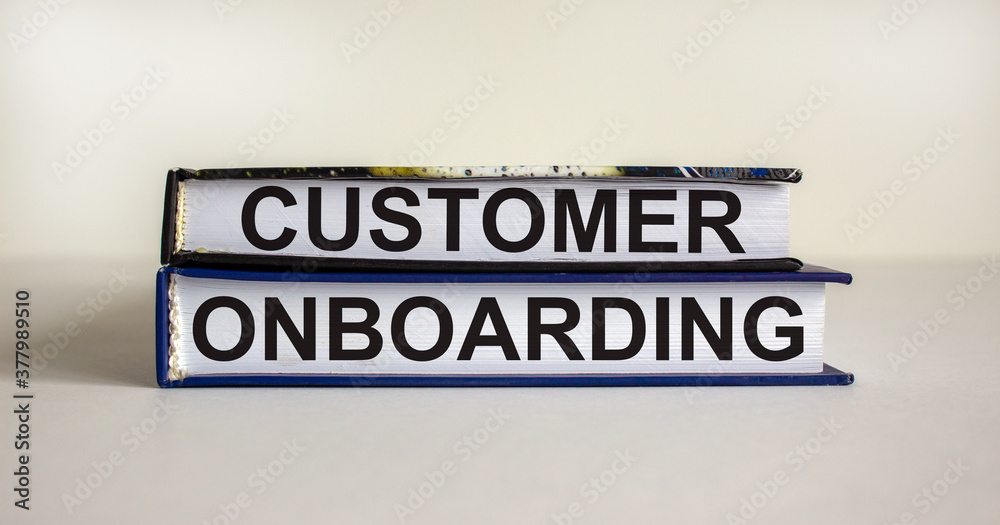 Books with text 'customer onboarding' on beautiful white table. White background. Business concept. Copy space. Books with text 'customer onboarding' on beautiful white table. White background. Business concept. Copy space.