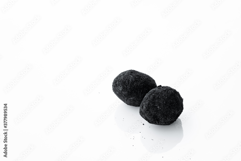 Fototapeta premium An old duck egg recipe in ash. Salty pickled duck egg in ash on a white background