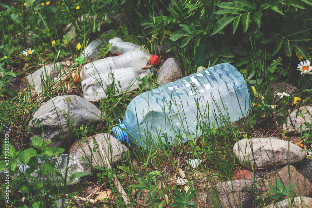 Obraz premium environmental pollution, ecological problem, spilled plastic bottles, garbage on the ground, waste, earth, ocean pollution