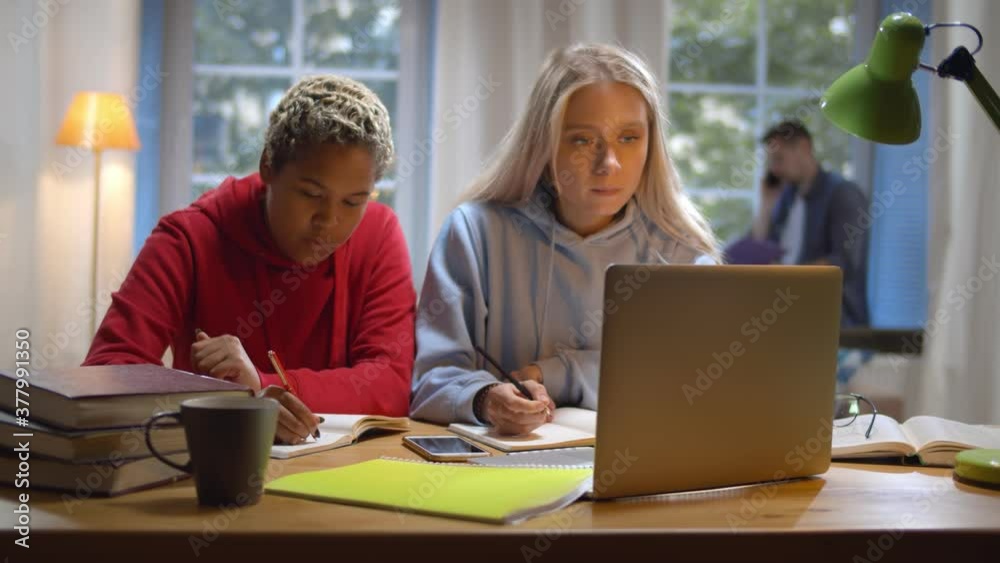 college students studying together at dorm and working on project college students studying together at dorm and working on project