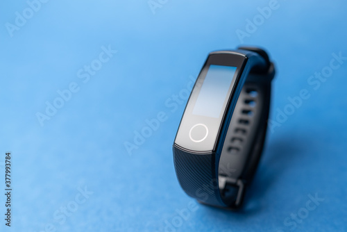 fitness bracelet on blue background