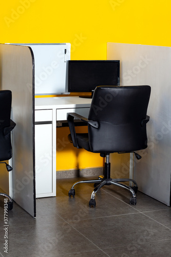 Workplace. Business office. Fashion and modern office interiors. White tables and black leather chairs. A concept of financial consulting services.