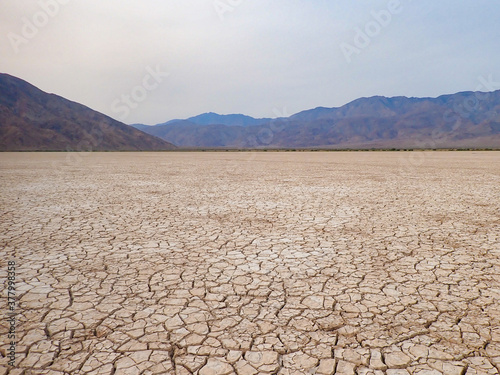 Cracked Dry Lake bed with Mountain background