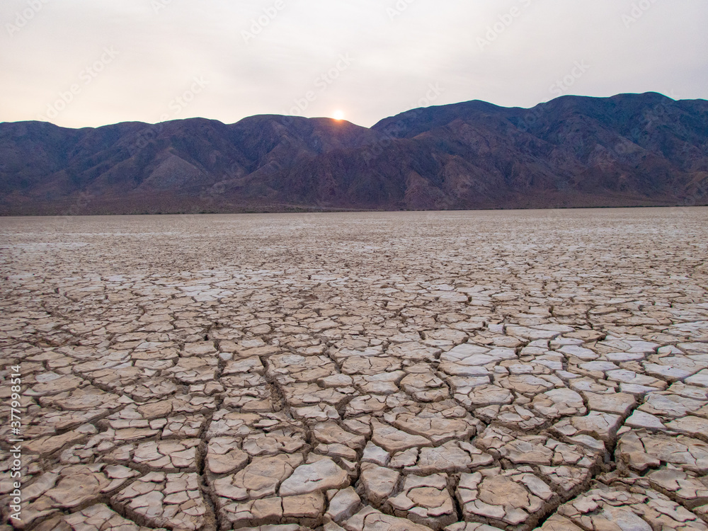 Cracked Dry Lake bed with Mountain background
