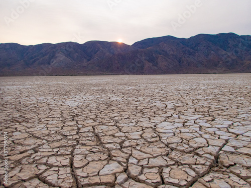 Cracked Dry Lake bed with Mountain background