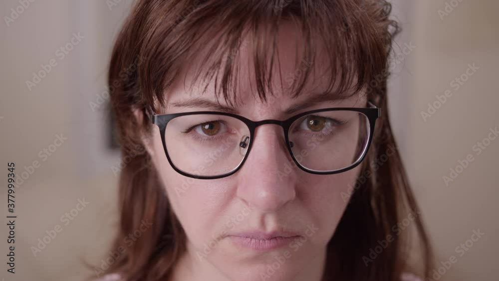 tired sad woman with glasses looking at the camera, moving camera tired sad woman with glasses looking at the camera, moving camera
