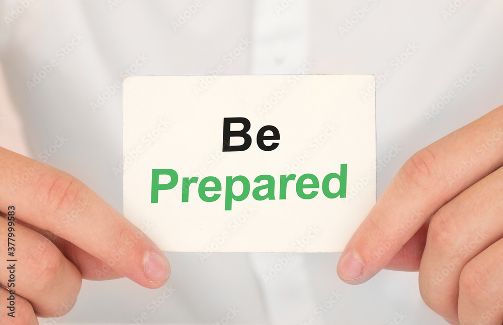 Man's hands take a card with words Be prepared, finance and business concept. Man's hands take a card with words Be prepared, finance and business concept.