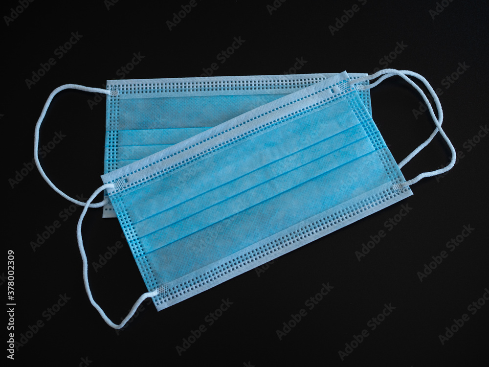 Doctor mask and corona virus protection isolated on a black background Doctor mask and corona virus protection isolated on a black background
