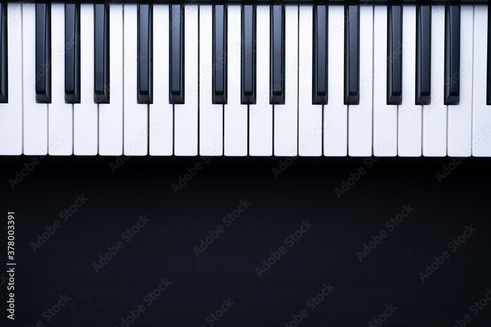 PIANO KEYS ON BLACK BACKGROUND WITH COPY SPACE FOR TEXT. TOP VIEW.
PIANO KEYS ON BLACK BACKGROUND WITH COPY SPACE FOR TEXT. TOP VIEW.