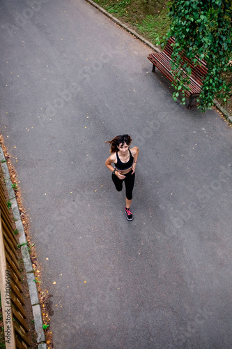 Photos Aerial view of female athlete running on a road