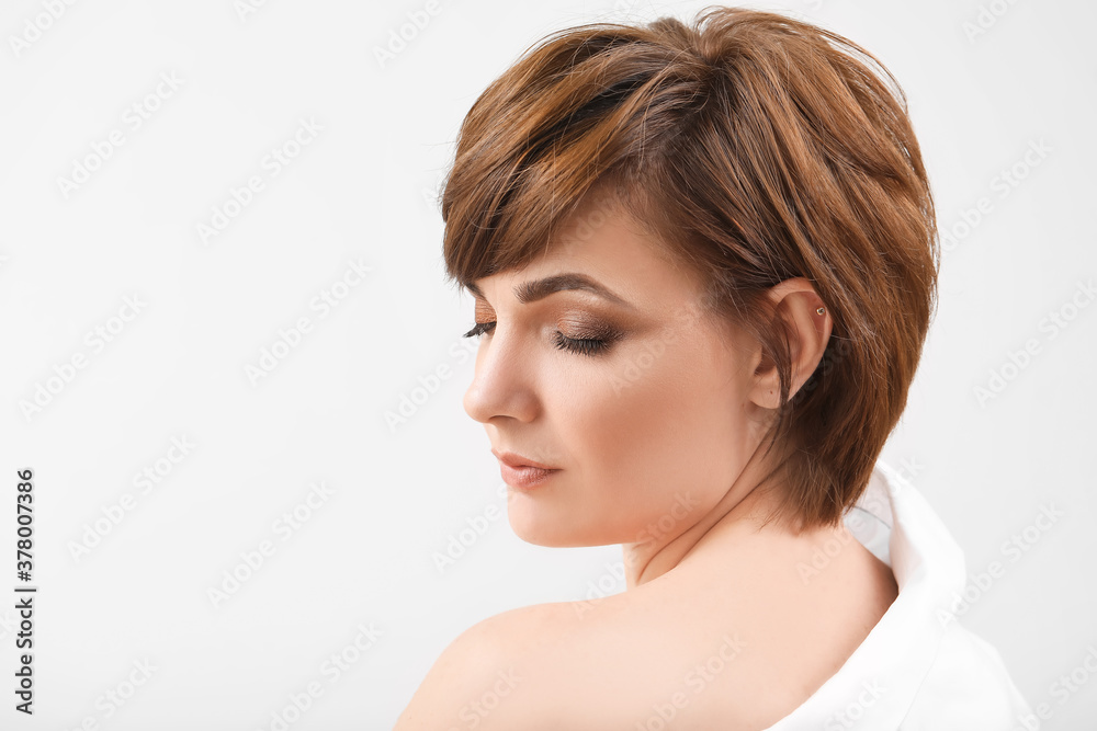 Young woman with beautiful short hair on grey background Young woman with beautiful short hair on grey background