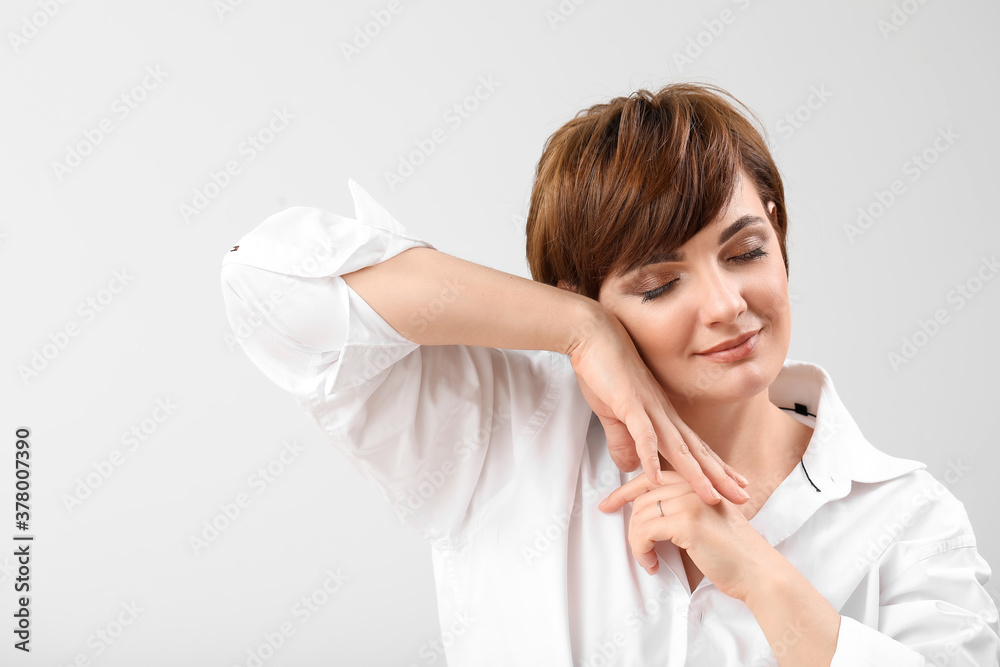 Young woman with beautiful short hair on grey background Young woman with beautiful short hair on grey background
