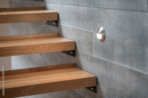 Wooden stairs against concrete block wall