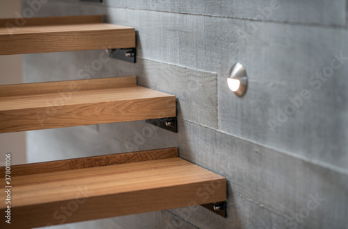 Wooden stairs against  concrete block wall